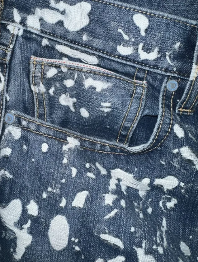 Close-up of bleach splatter effect on indigo denim