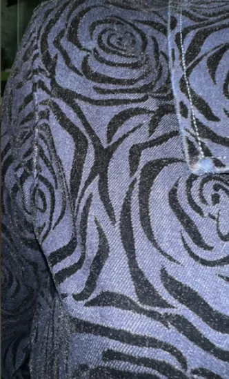 Laser-etched rose pattern on denim