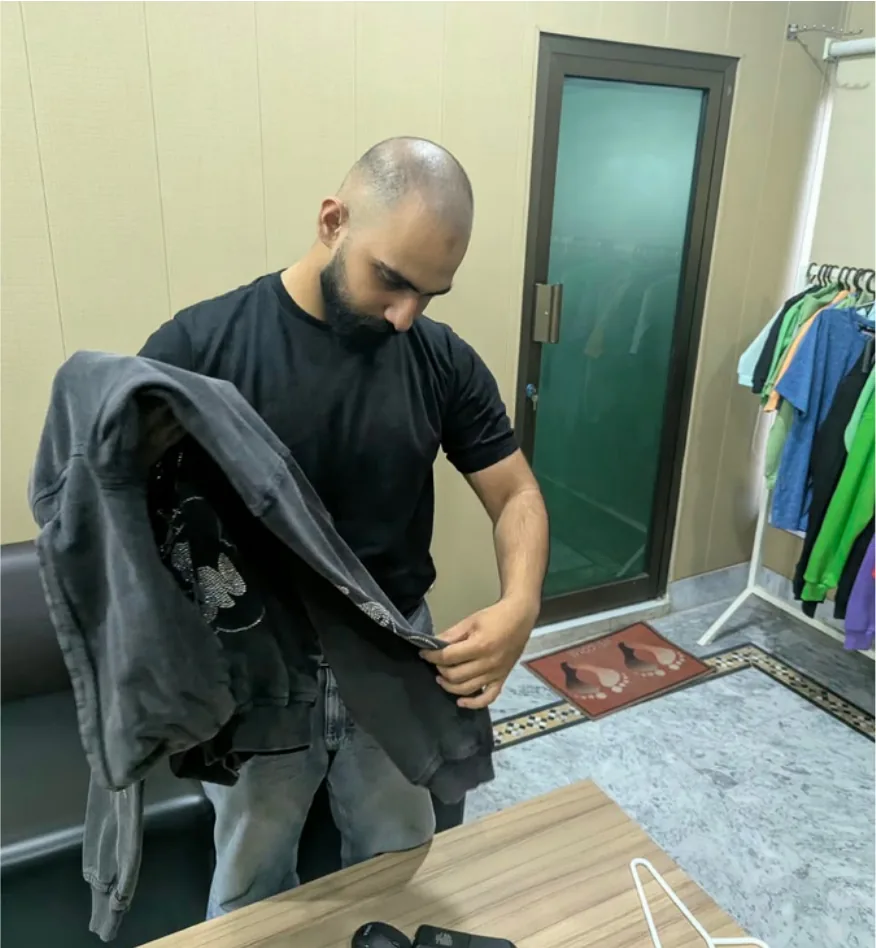 Reviewing a garment sample in the studio